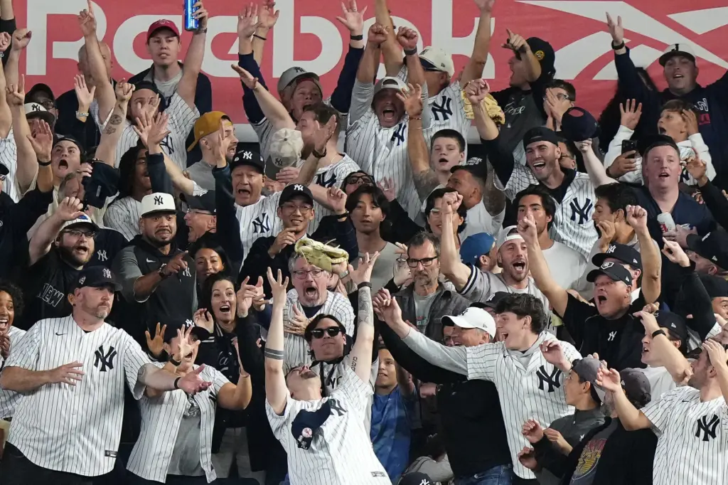 A fan catches the ball that was hit for a...
