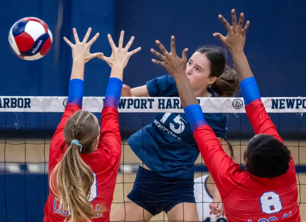 Newport Harbor middle blocker Morgan Starkenburg (15) hits the ball...