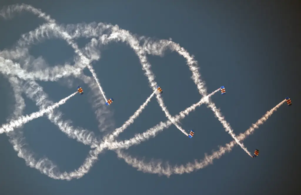 The Royal Air Force Falcons parachute team jump over the...