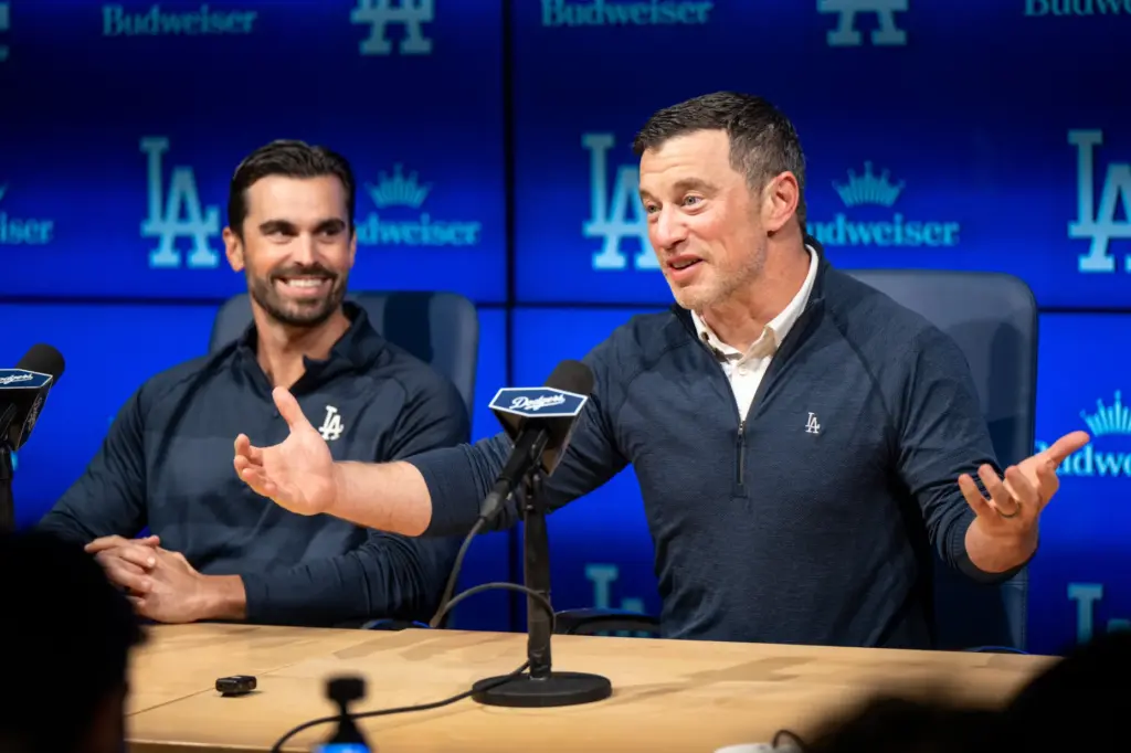 Dodgers president of baseball operations Andrew Friedman, right, speaks to...