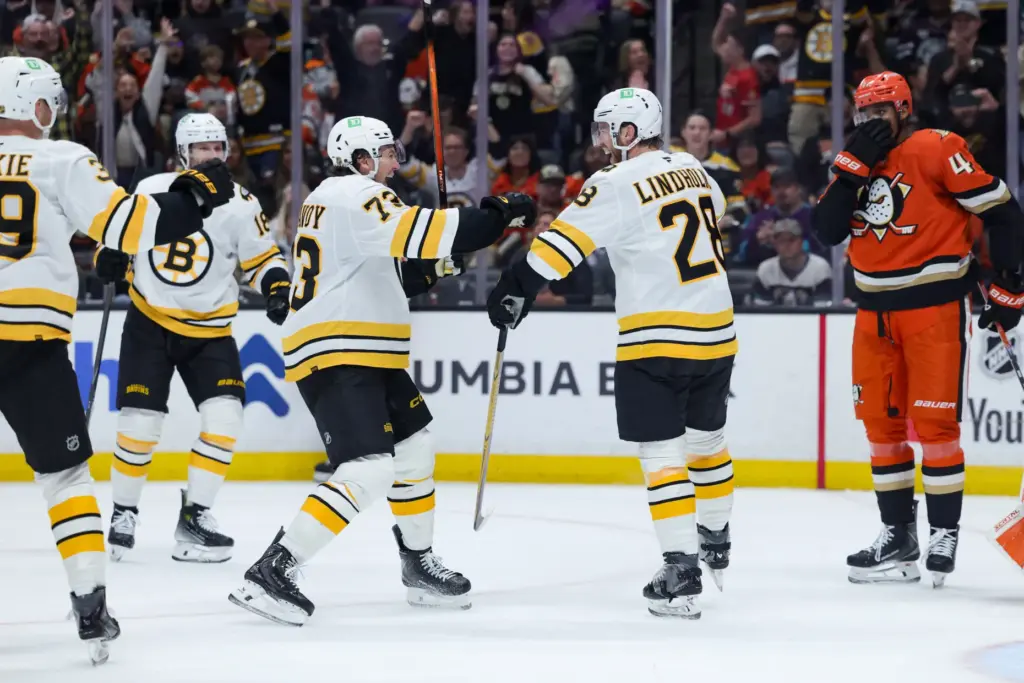 Boston Bruins center Elias Lindholm, second from right, celebrates with,...