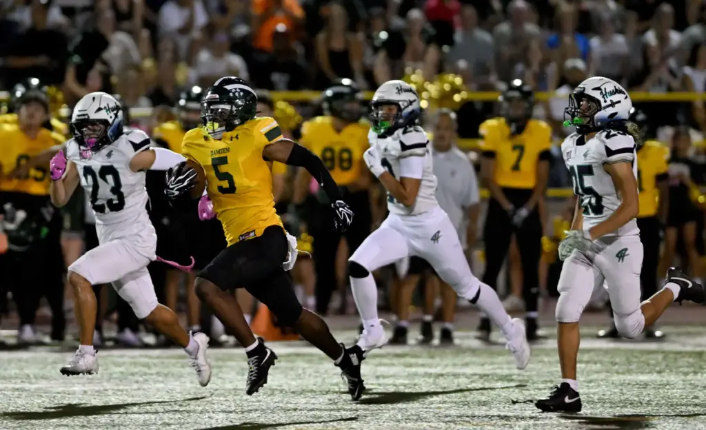 Damien Spartans Dupri Stevenson-Dorsey (5) runs the ball back on...