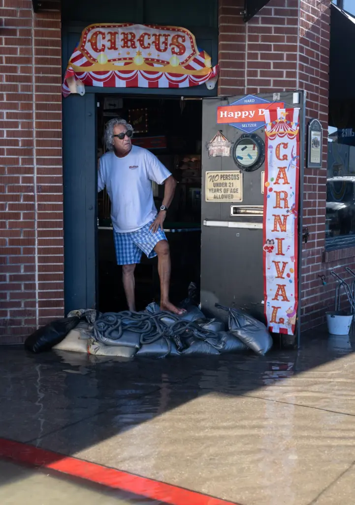 Jeff Arzouman watches the flooding from inside the Balboa Saloon,...