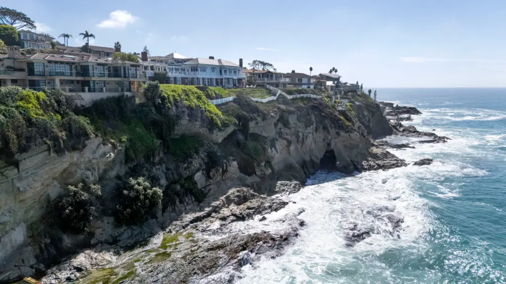 Waves crash on the rocks at the south end of...