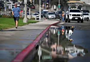 Surging surf floods onto Broadway and Coast Highway in Laguna Beach