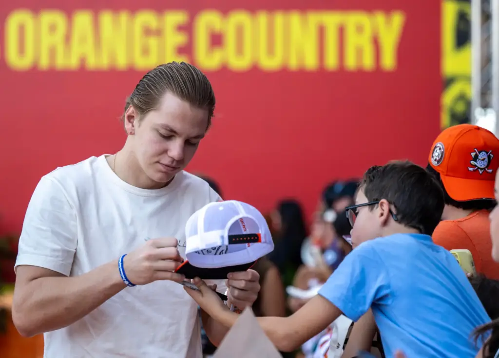 Ducks player Pavel Mintyukov signs an autograph for a fan...