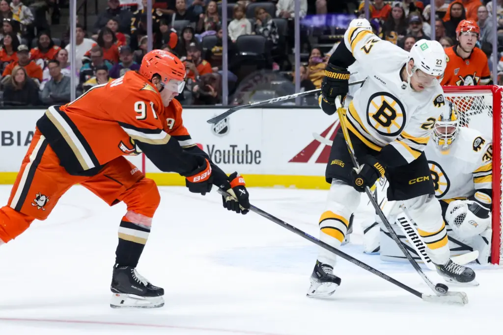 Boston Bruins defenseman Hampus Lindholm, right, and Ducks center Leo...
