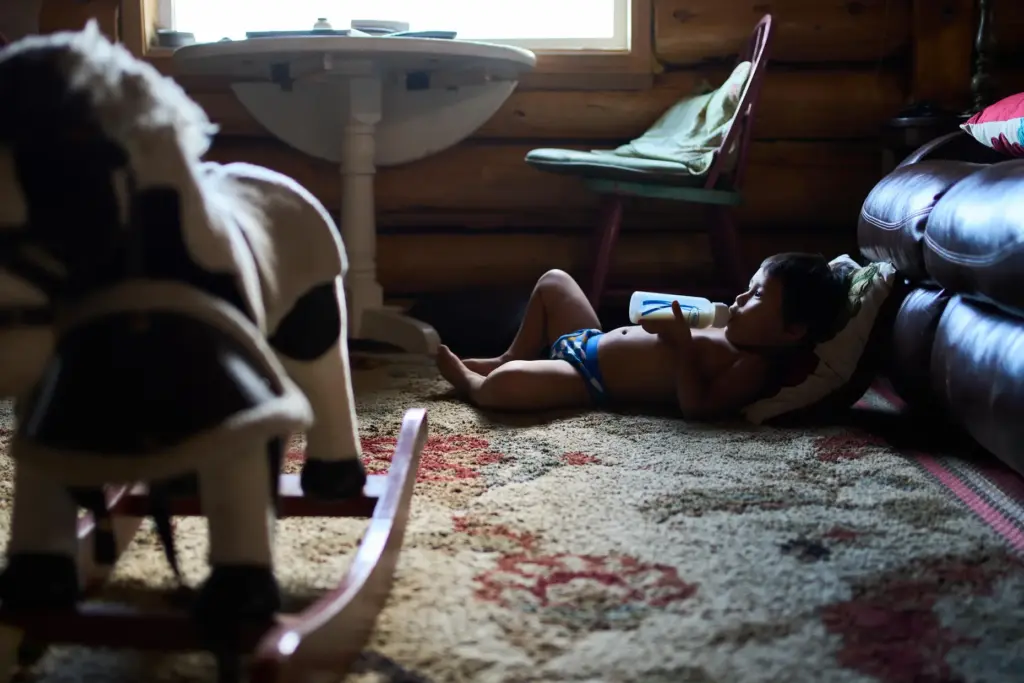 Lewis Thomas watches TV at his home in Rampart, Alaska,...