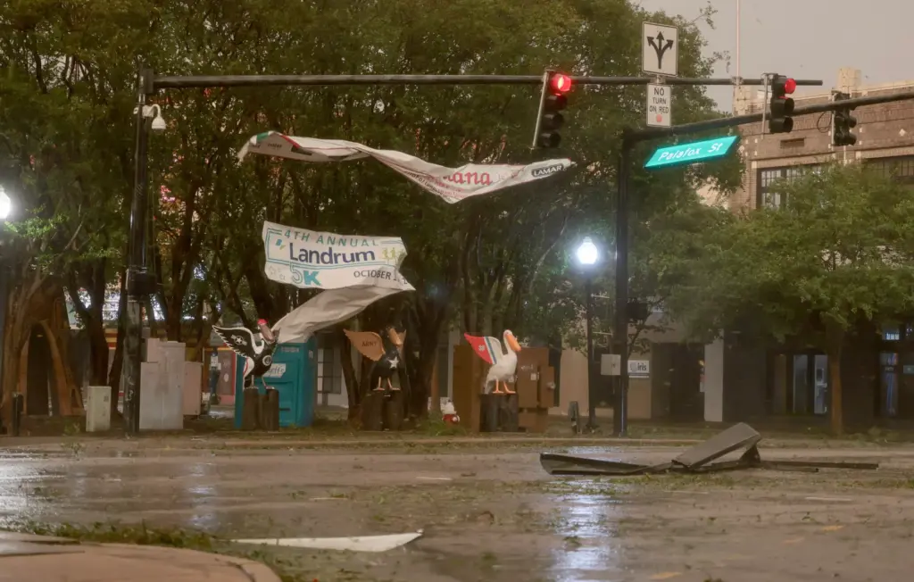 Debris flies about an intersection as wind and rain from...
