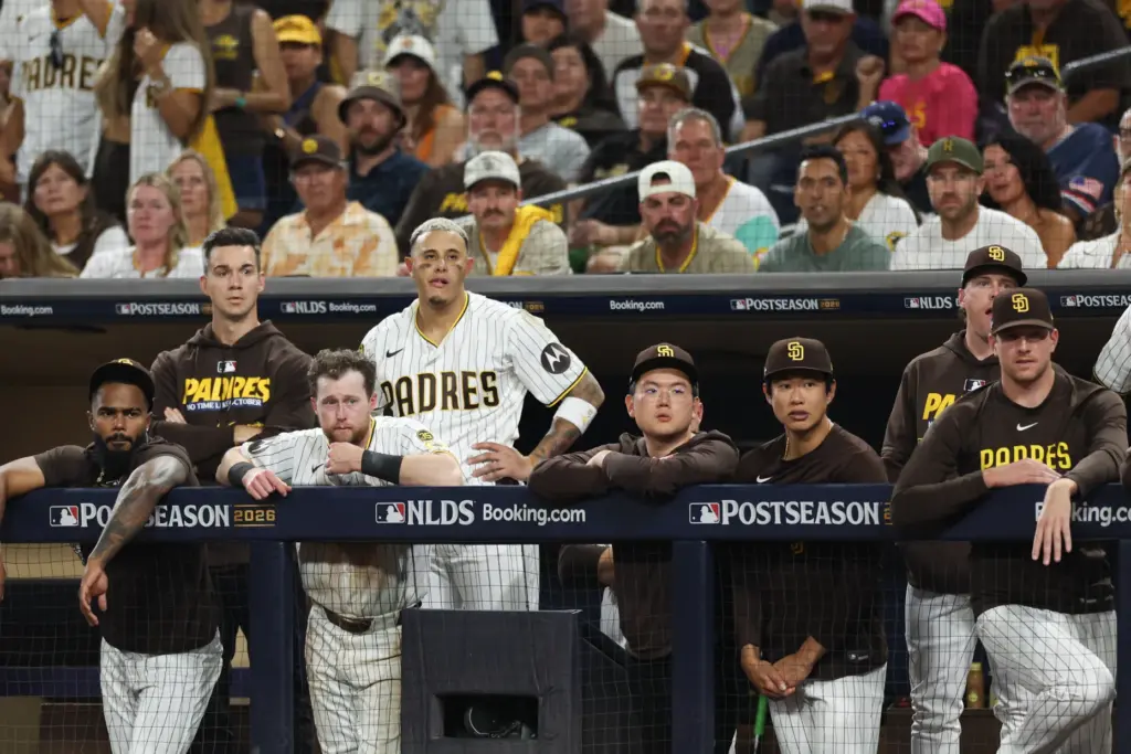 San Diego Padres players watch from the dugout during the...