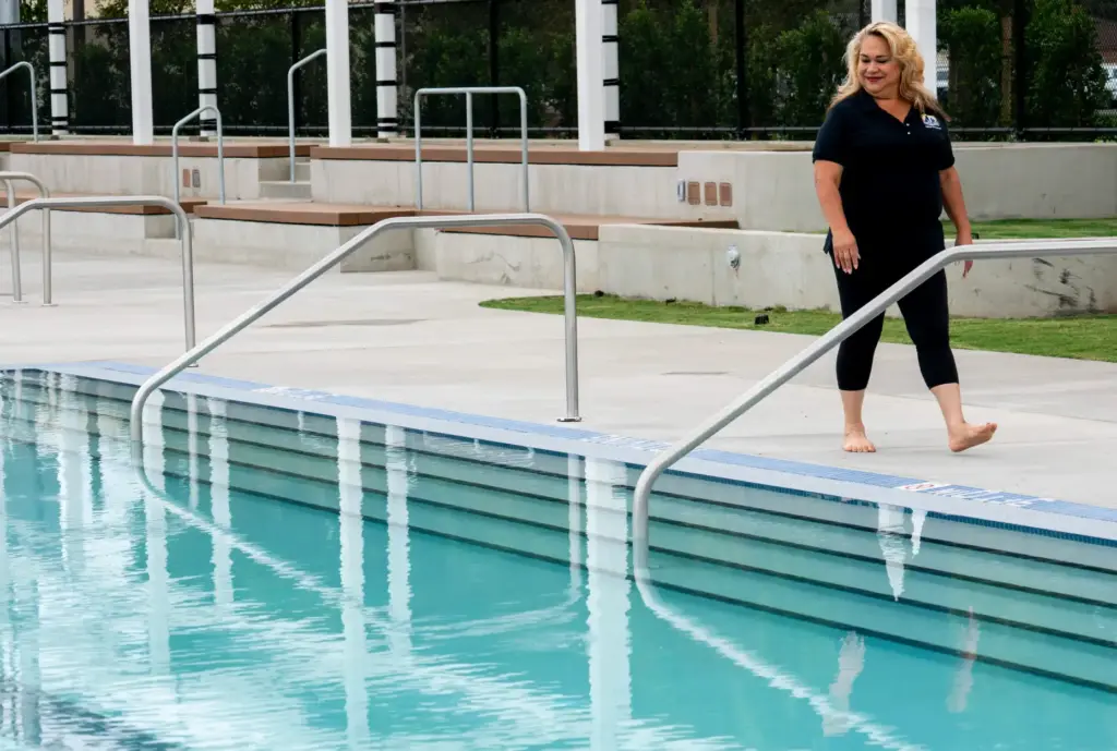 Santa Ana Mayor Valerie Amezcua walks beside the recreational pool...