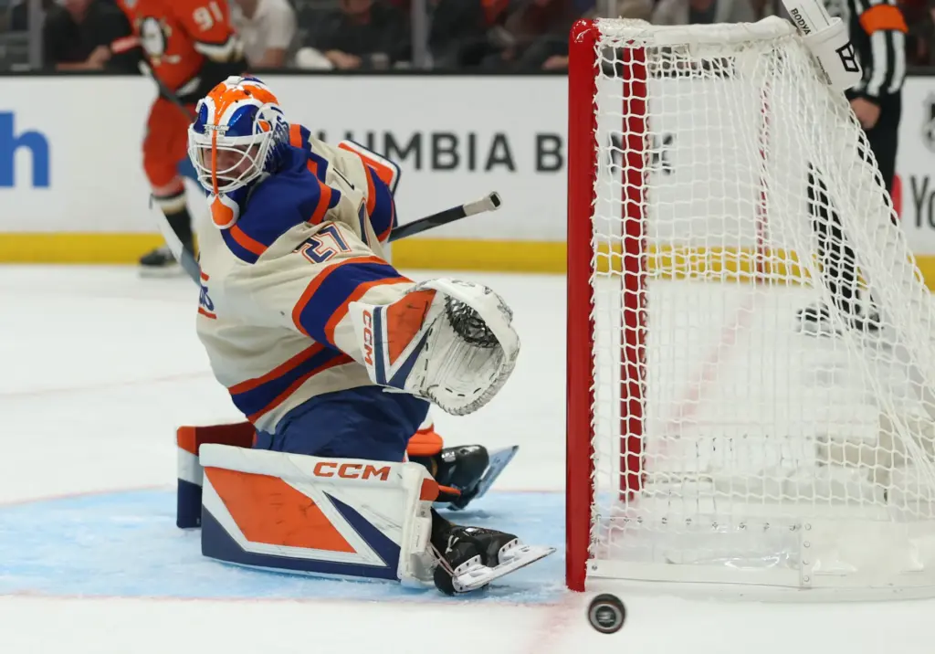 Edmonton Oilers goaltender Devon Levi deflects a shot wide of...