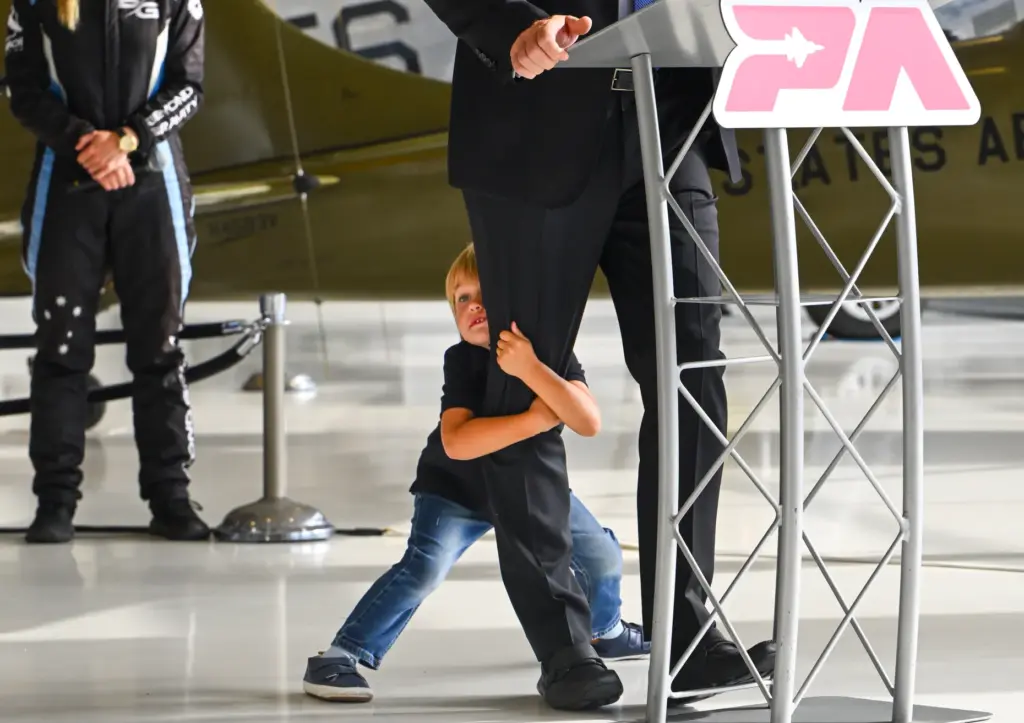 Jet Elliot hold on to his father, Kevin Elliott, CEO...
