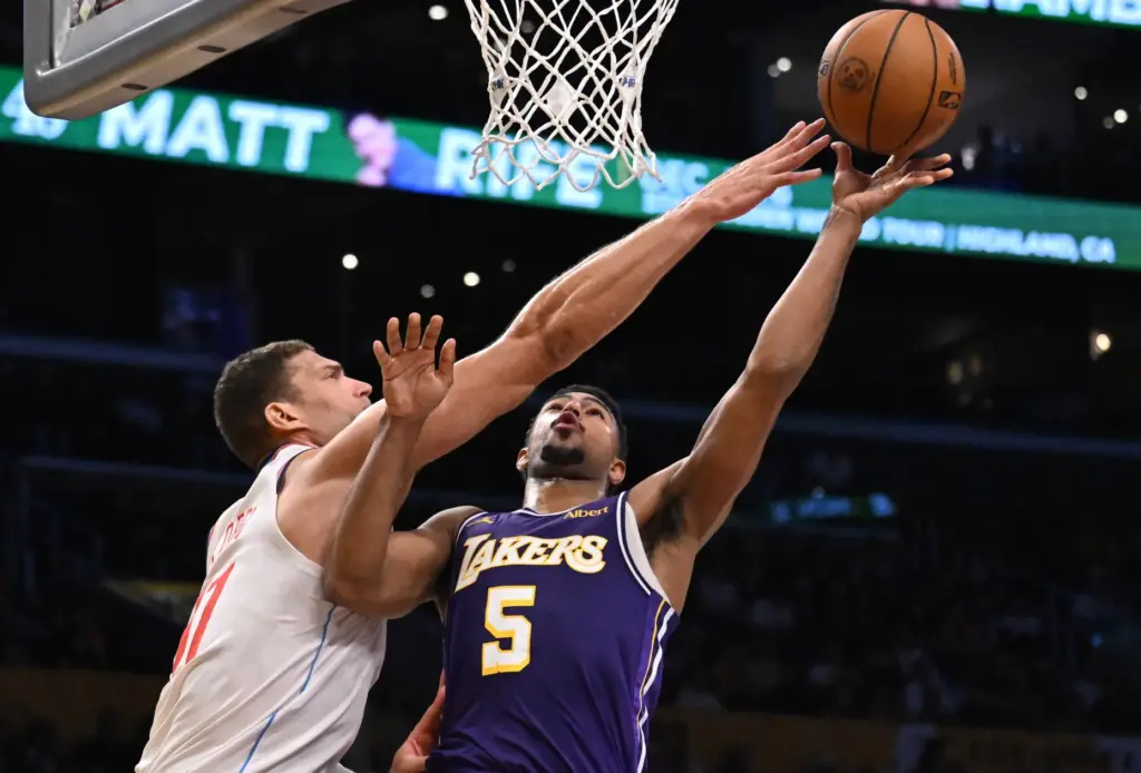 Clippers center Brook Lopez, left, reaches to try to block...