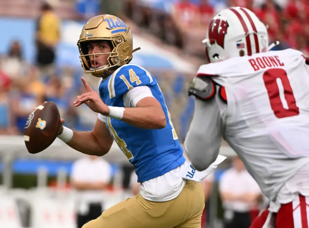 UCLA quarterback Ty Dieffenbach passes against linebacker Justus Boone of...