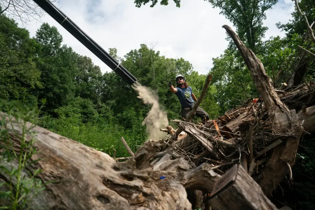 Workers from MountainTrue clear IPEX PVC pipe from the riverbank...