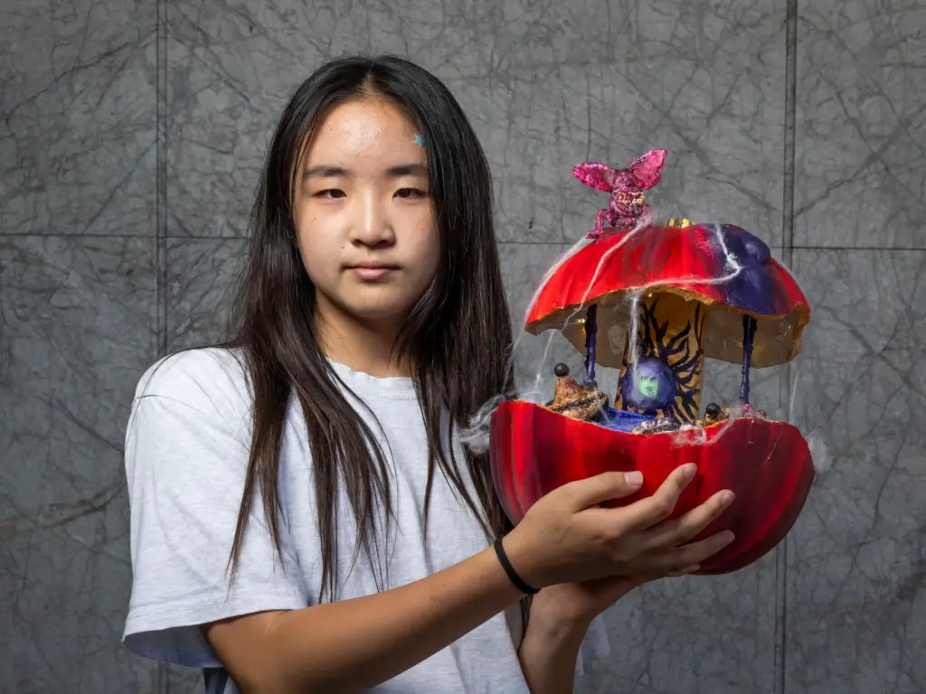 Chloe Hur holds her pumpkin titled âOnce Upon a Nightmareâ...
