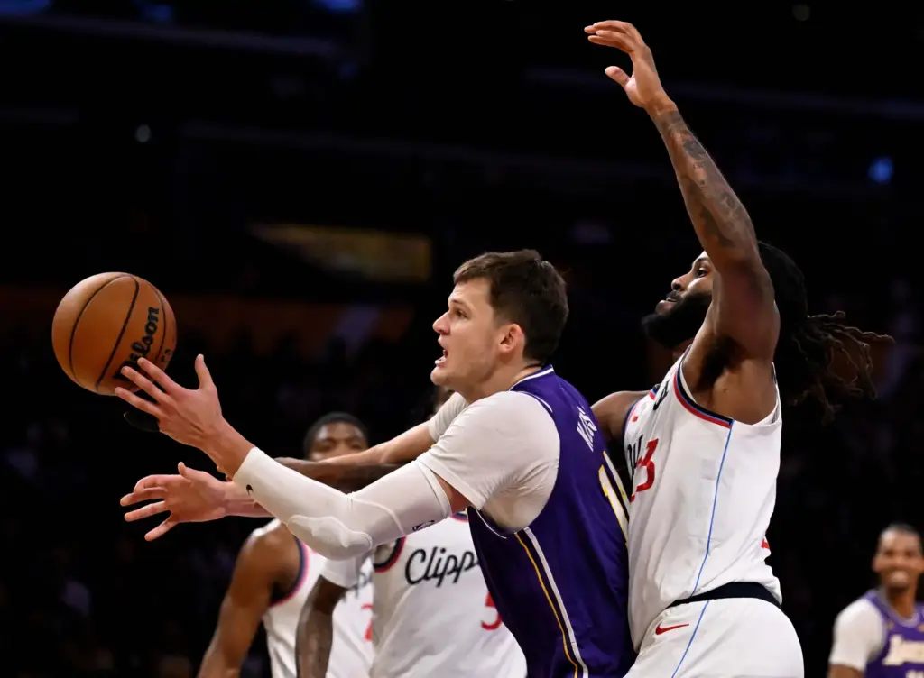 Lakers center Walker Kessler, left, is fouled by Clippers forward/center...