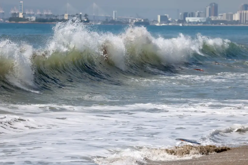 High surf approaches the boardwalk along the Peninsula in Long...