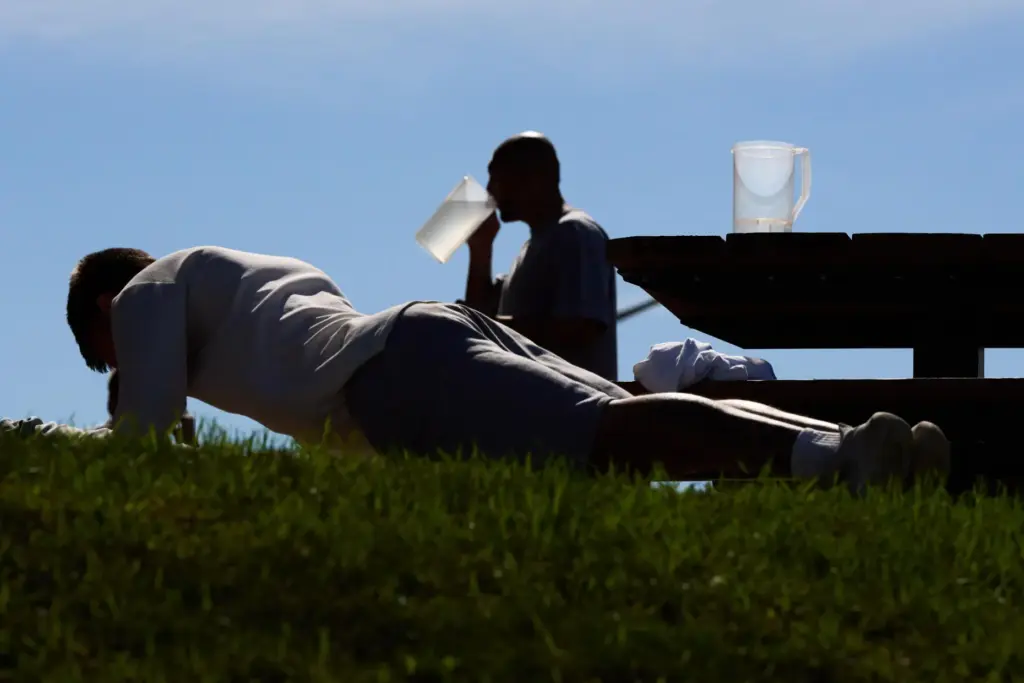 People who are incarcerated exercise and drink water at the...