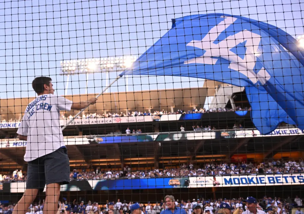 A member of the Dodgers Blue Crew waves a flag...