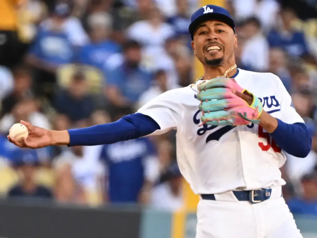 Dodgers shortstop Mookie Betts throws out the Milwaukee Brewers’ Jackson...