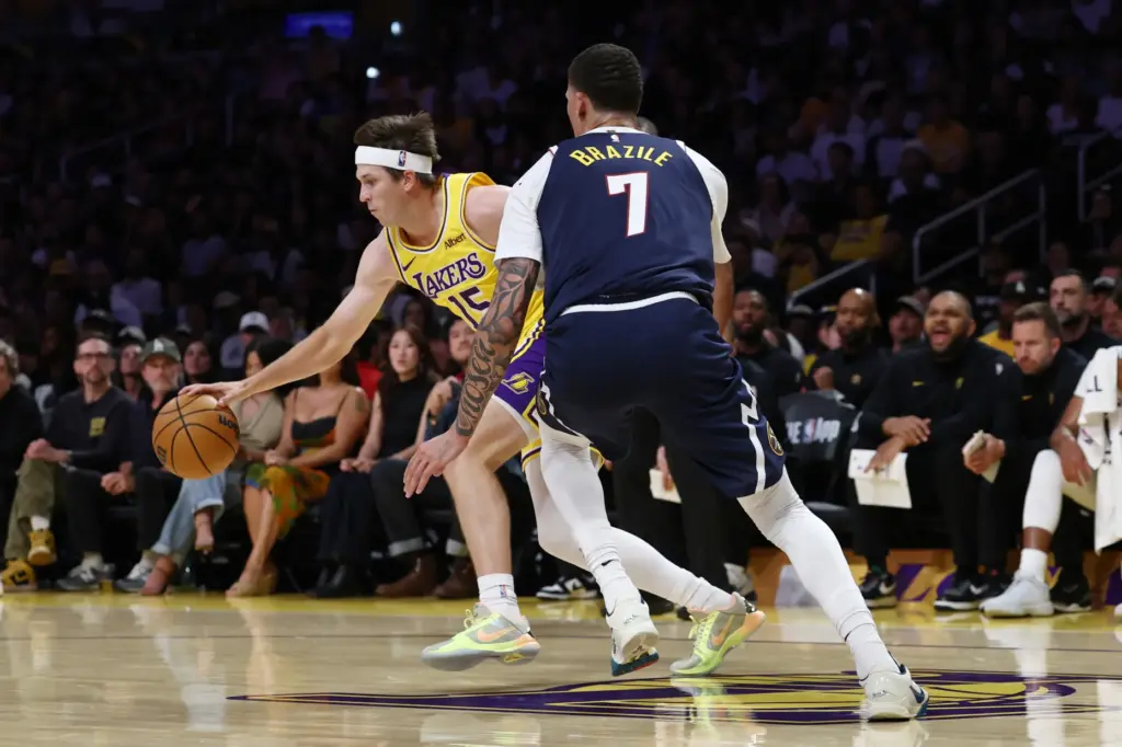 Lakers guard Austin Reaves drives to the basket as Denver...