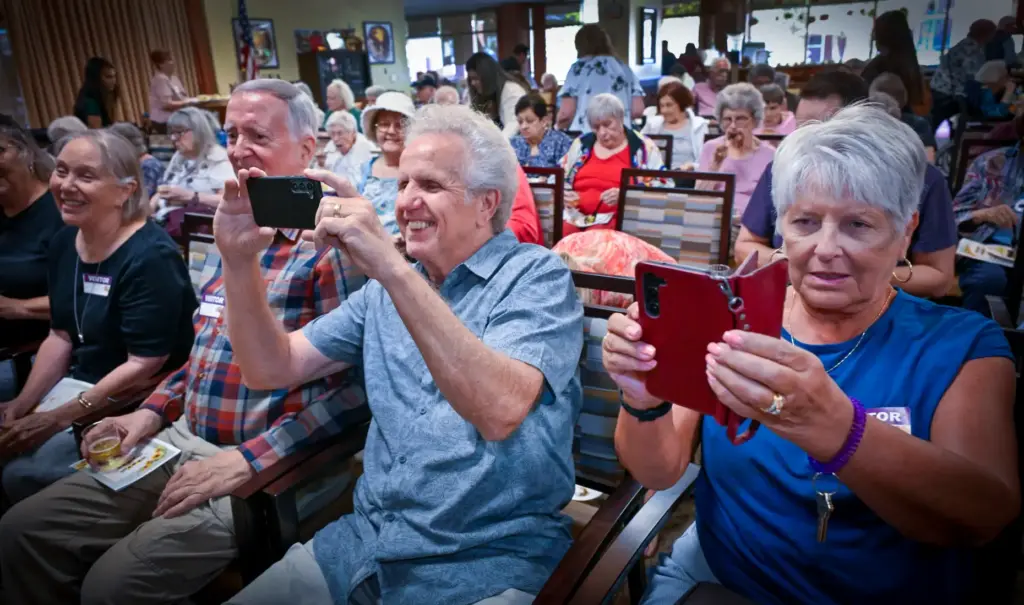 Family and friends take photos as they help to celebrate...