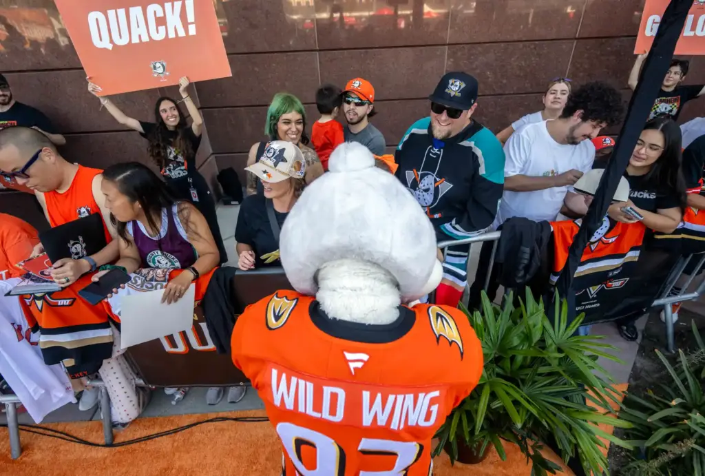 Wild Wing signs autographs for Ducks fans on the orange...