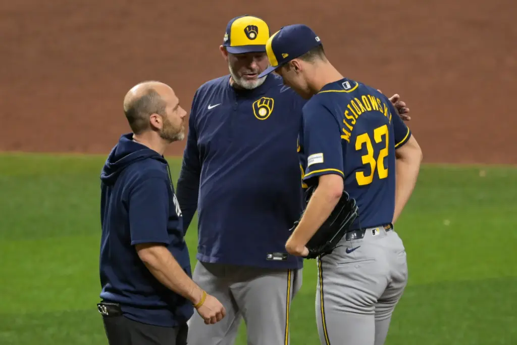 Milwaukee Brewers starting pitcher Jacob Misiorowski talks with head athletic...