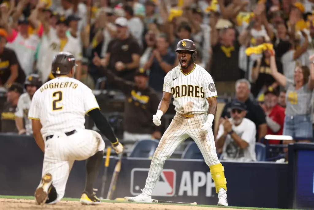 The San Diego Padres’ Samad Taylor, right, celebrates as teammate...