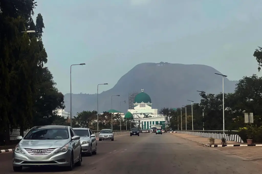 FILE – Cars drive past the National Assembly building in...