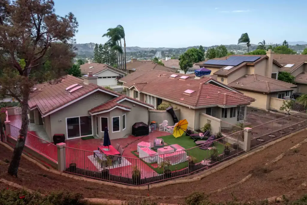 Pink fire retardant covers a backyard near Via Capri in...
