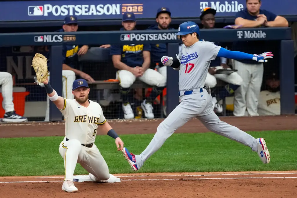 Dodgers star Shohei Ohtani, right, is thrown out on a...