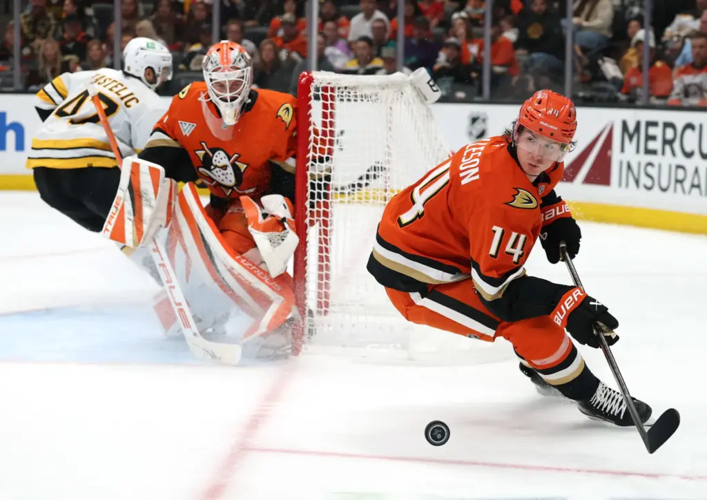 The Ducks’ Drew Helleson looks back for the puck as...