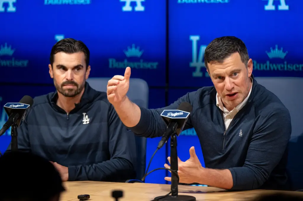 Dodgers president of baseball operations Andrew Friedman, right, speaks to...