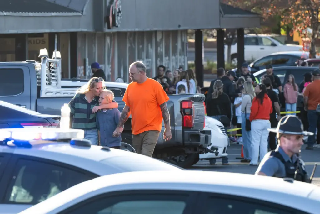 People leave a family meeting area following a shooting at...