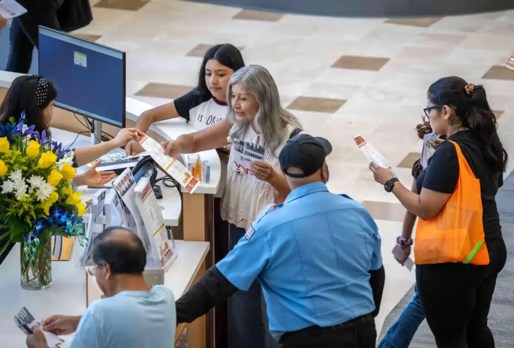 Residents sign up for library cards at the front desk...