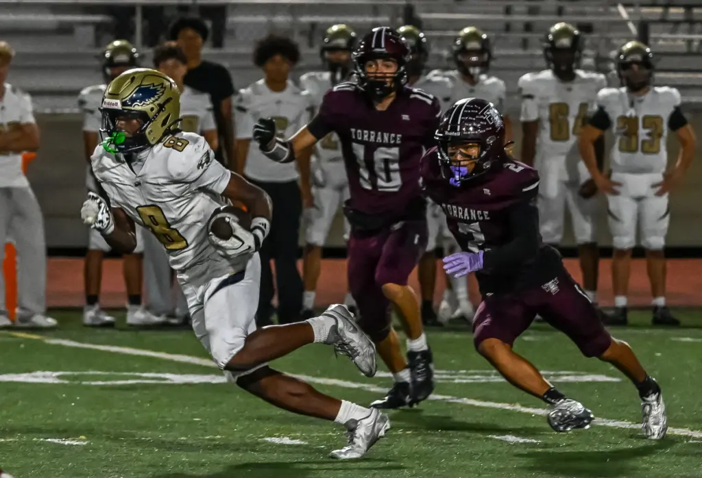 El Segundo wide receiver Ezekiel Sea runs with the ball...
