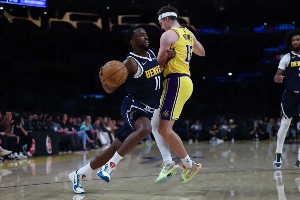 Denver Nuggets forward Alpha Diallo, left, drives past Lakers guard...