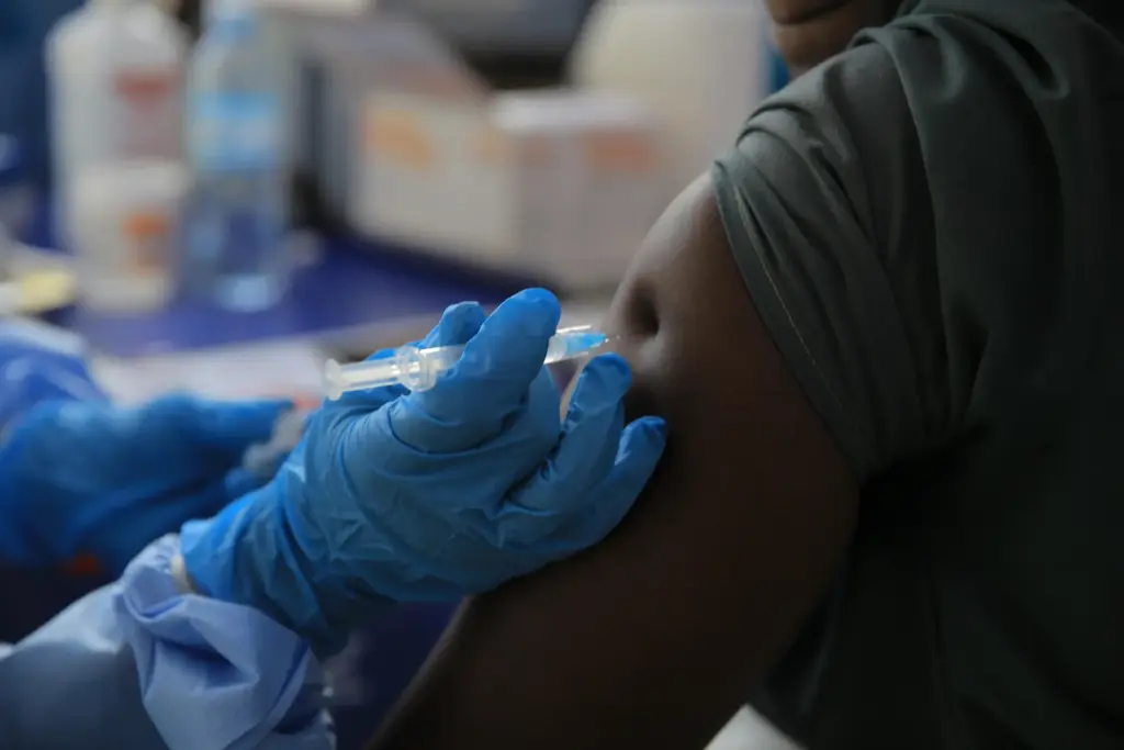 A healthcare worker administers a dose of Ervebo vaccine against the Ebola virus.