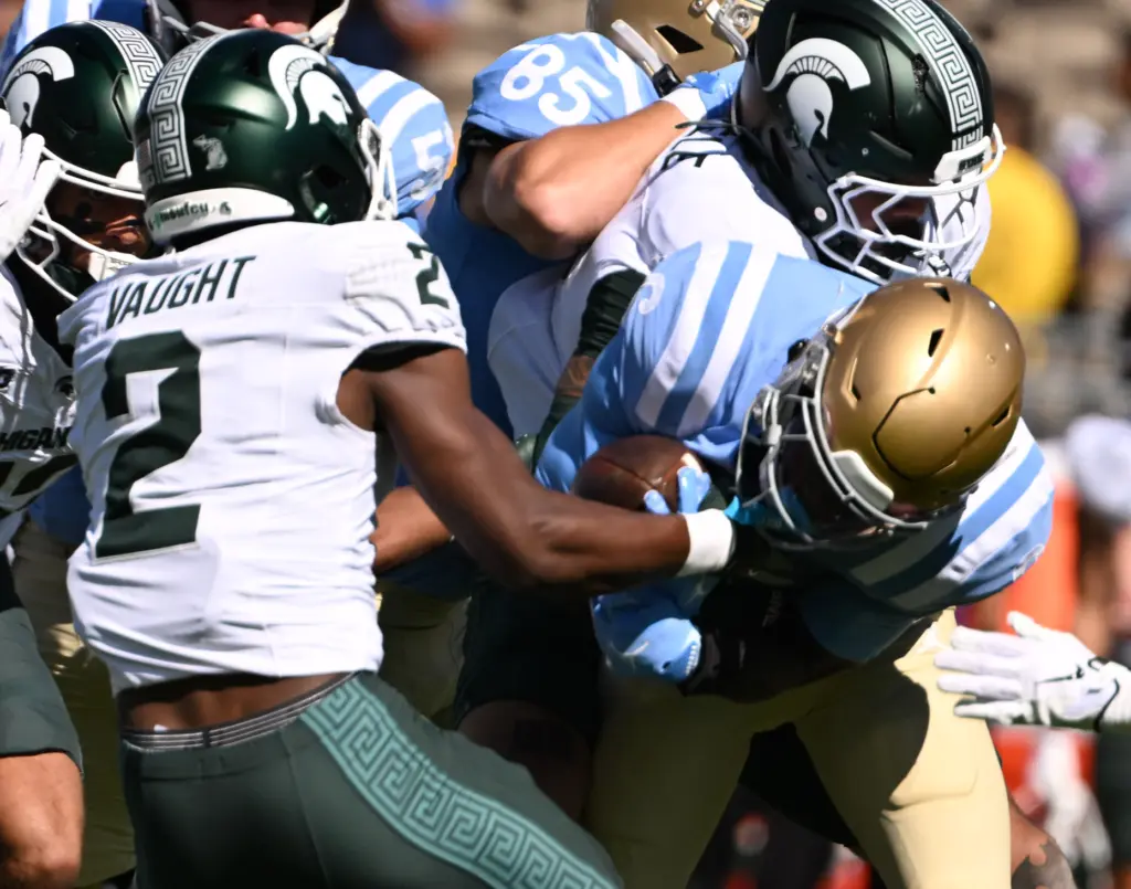 Michigan State safety Devin Vaught (2) strips the ball from...
