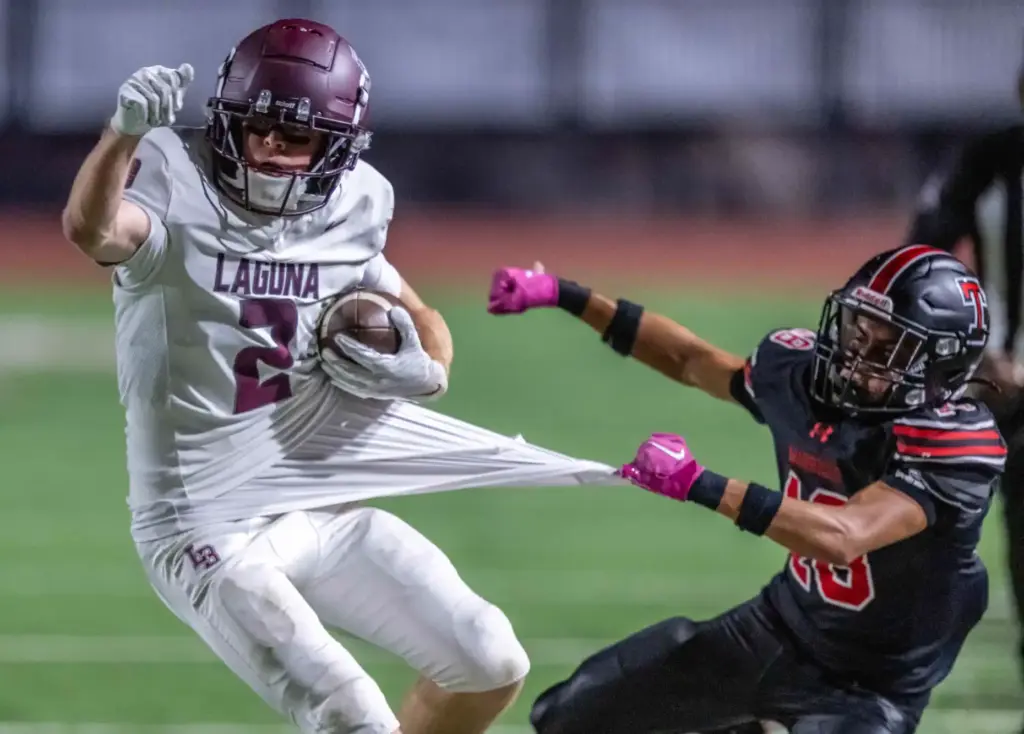 Laguna Beach wide receiver Brady Stringham (2) gets his jersey...