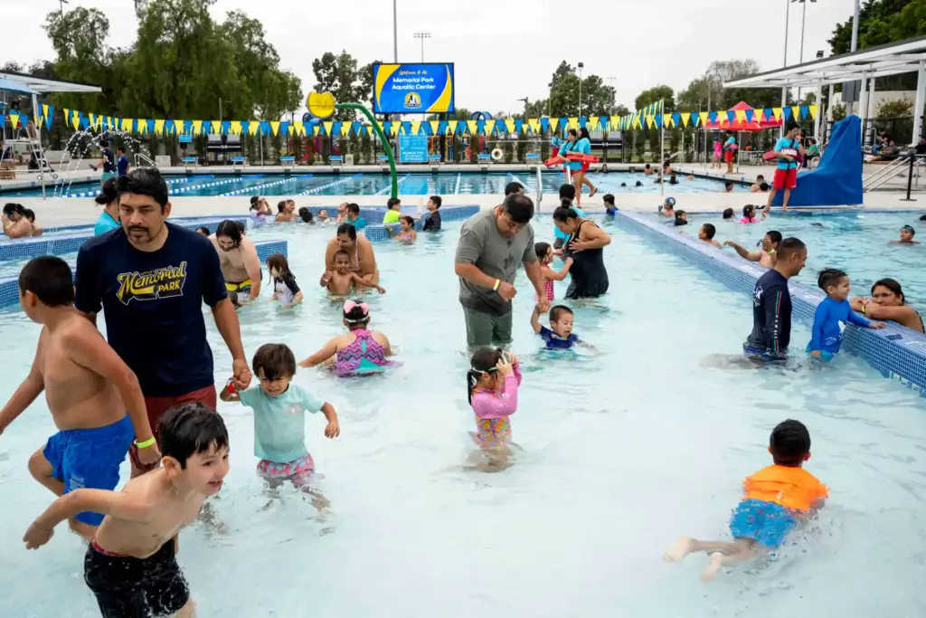 Community members enjoy the shallower pool at the new Memorial...