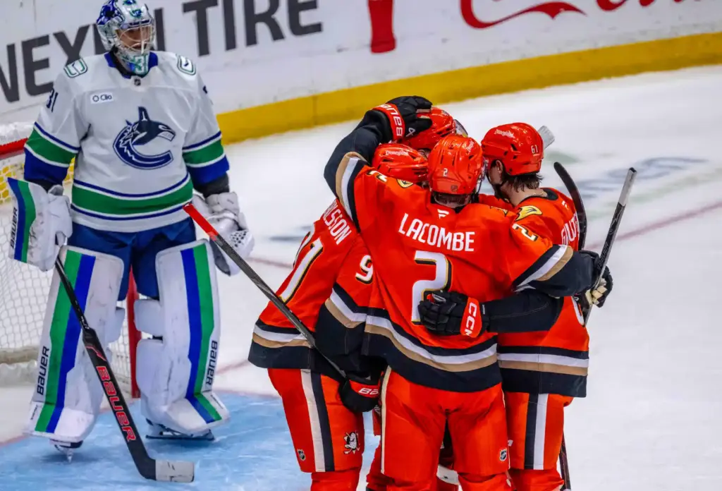 Ducks players celebrate a goal by Beckett Sennecke (45) as...