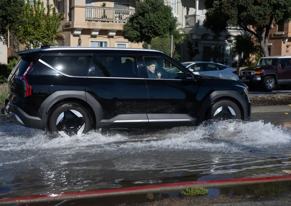 Cars push through flooding on Seal Beach Blvd. near PCH...
