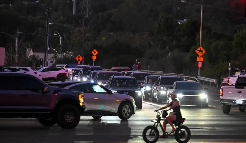 Cars, People, and Pedestrians converge at the corner of San...