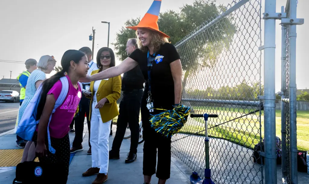 Principal Sarah Nead-Rendon greets students at Schmitt Elementary School in...