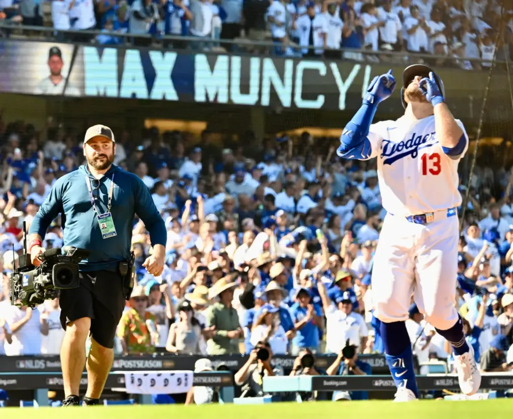 The Dodgers’ Max Muncy gestures as he crosses home plate...