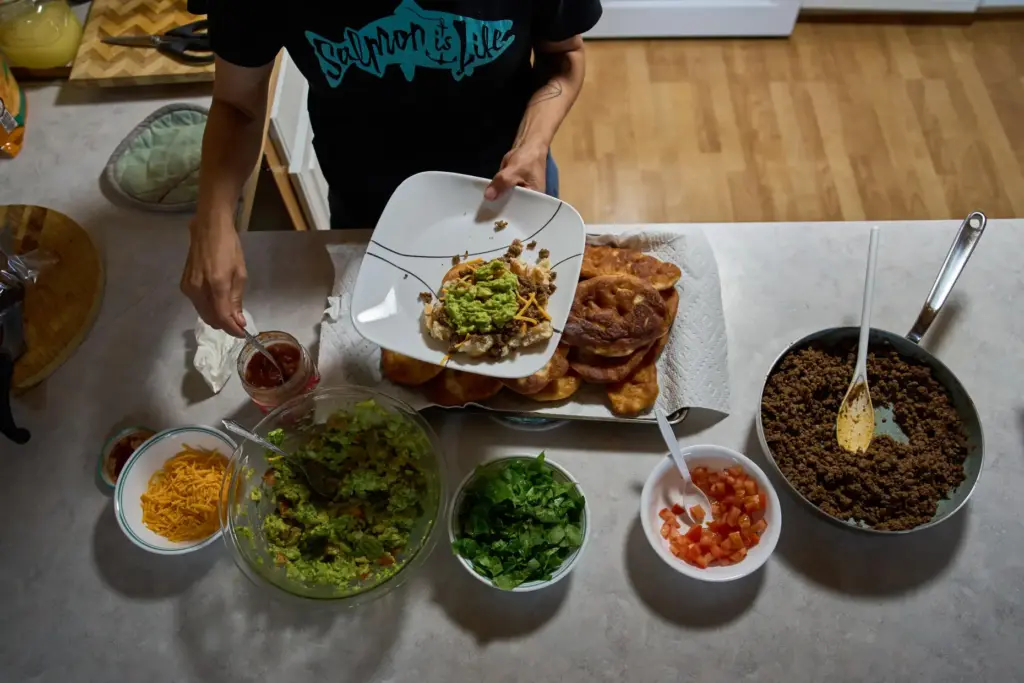 Brooke Woods serves herself moose meat tacos while wearing a...